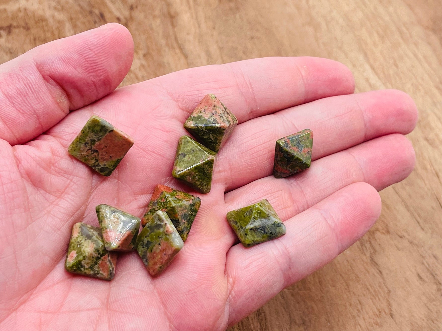 Unakite pyramid gemstone carving from GemstoneGO, 14mm size, featuring vibrant green and pink mineral patterns.