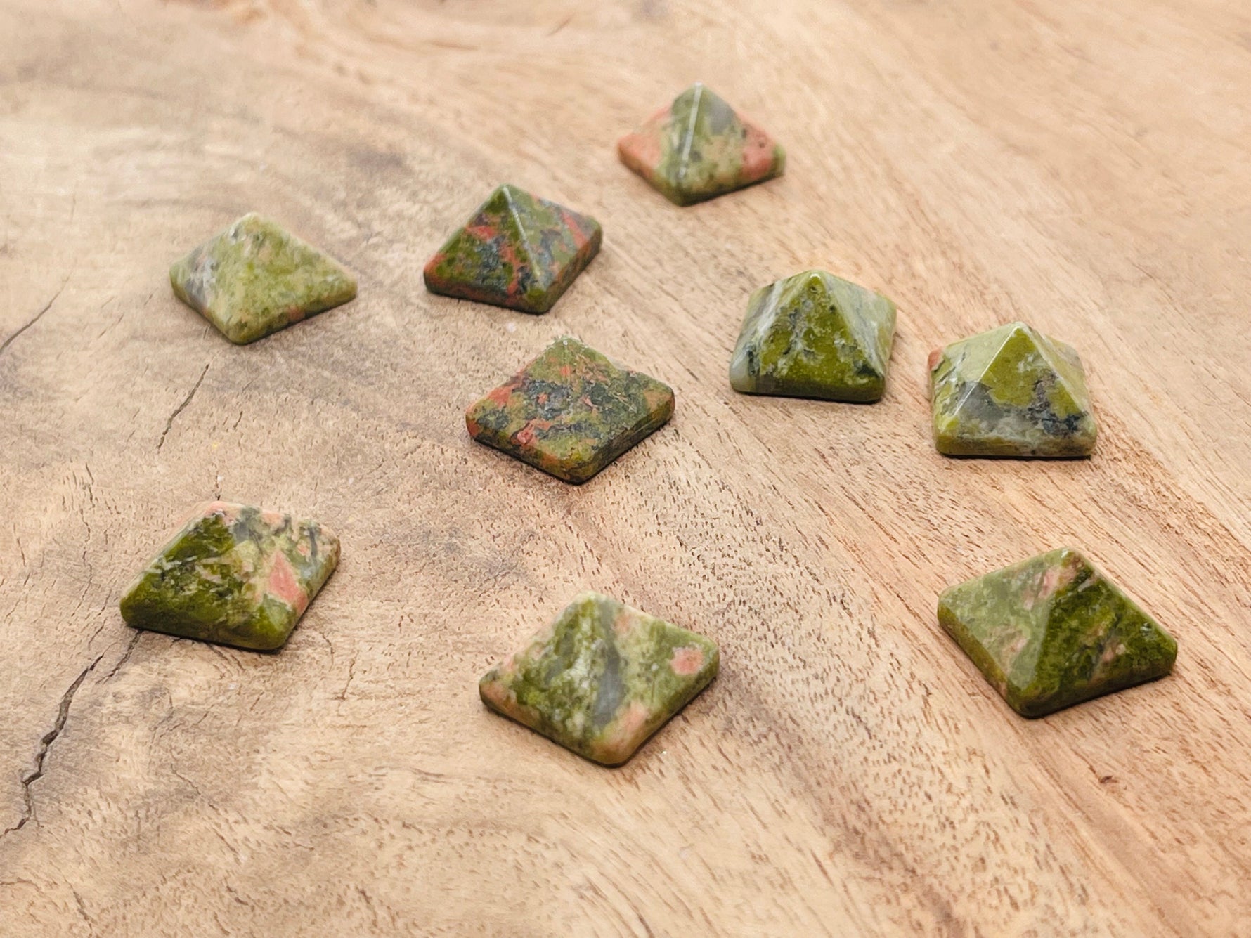 Unakite pyramid carving gemstone, 14mm, from GemstoneGO, featuring natural green and pinkish hues with smooth faceted surface.