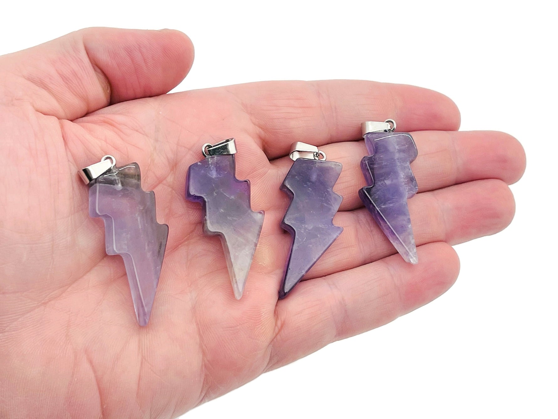 Amethyst Lightning Crystal Pendant by GemstoneGO featuring a striking lightning-shaped amethyst crystal pendant on a silver chain