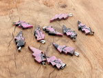 Rhodonite Lightning Crystal Pendant from GemstoneGO featuring a vibrant lightning stone gemstone on a silver chain.