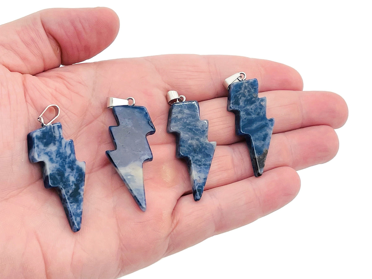 Sodalite Lightning Crystal Pendant from GemstoneGO featuring a striking lightning-shaped blue gemstone pendant on a silver chain.