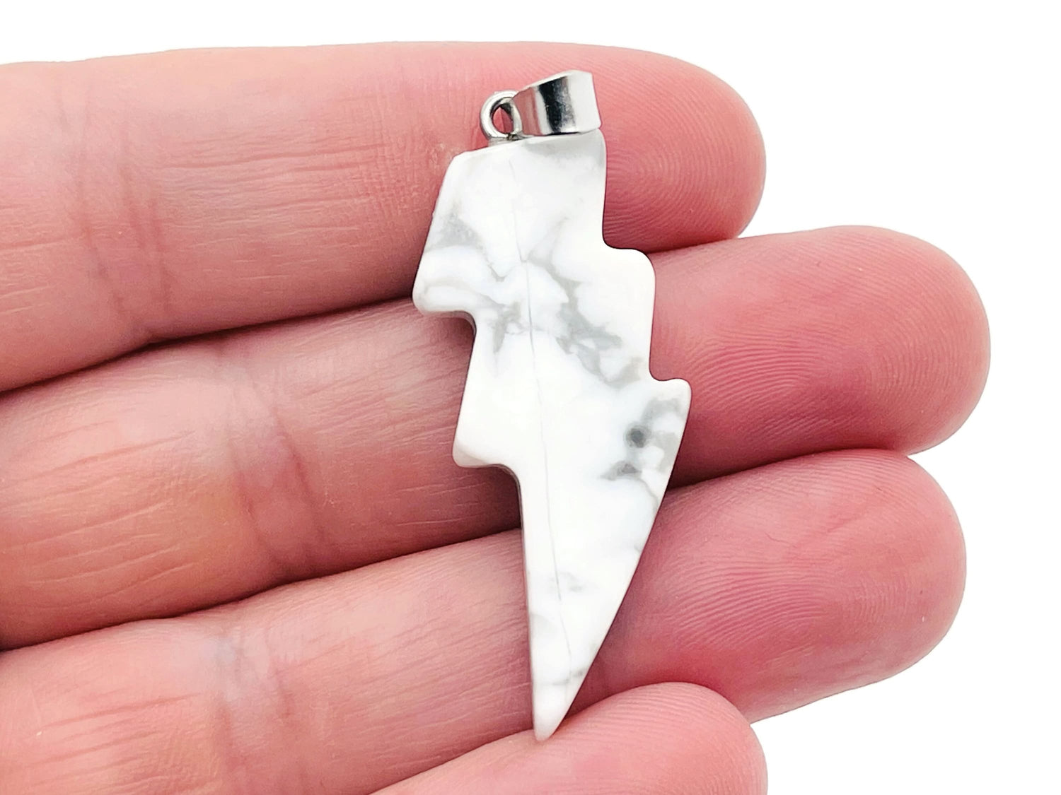 Howlite Lightning Crystal pendant from GemstoneGO featuring a striking lightning-shaped stone on a silver chain.
