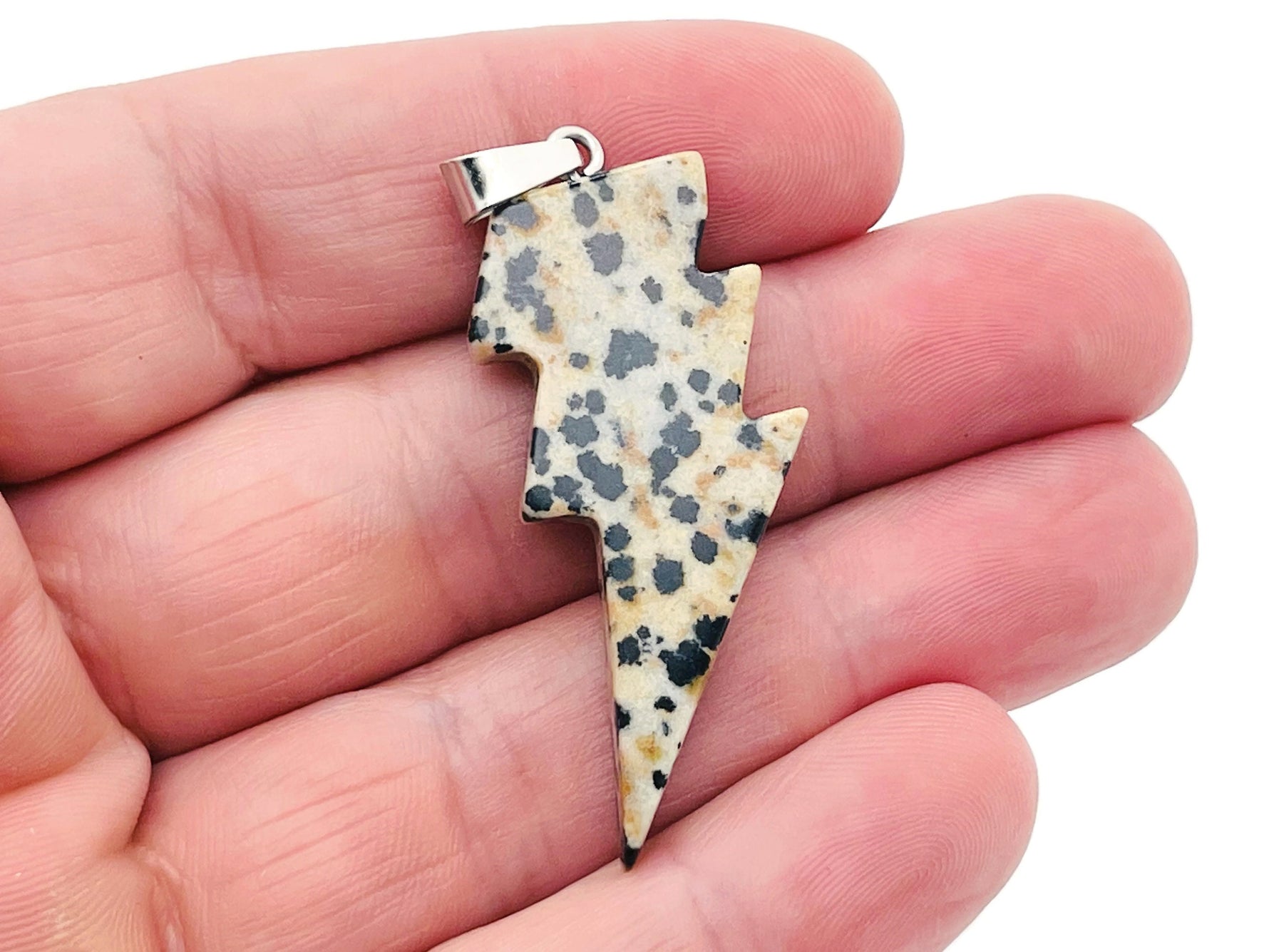 Dalmatian Jasper Lightning Crystal Pendant by GemstoneGO featuring a striking lightning-shaped jasper stone necklace.
