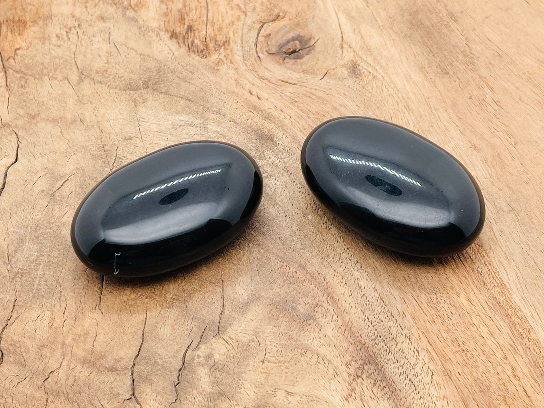 Obsidian palm gemstone spa stone, 60x40mm, smooth black volcanic stone for relaxation and massage, from GemstoneGO.
