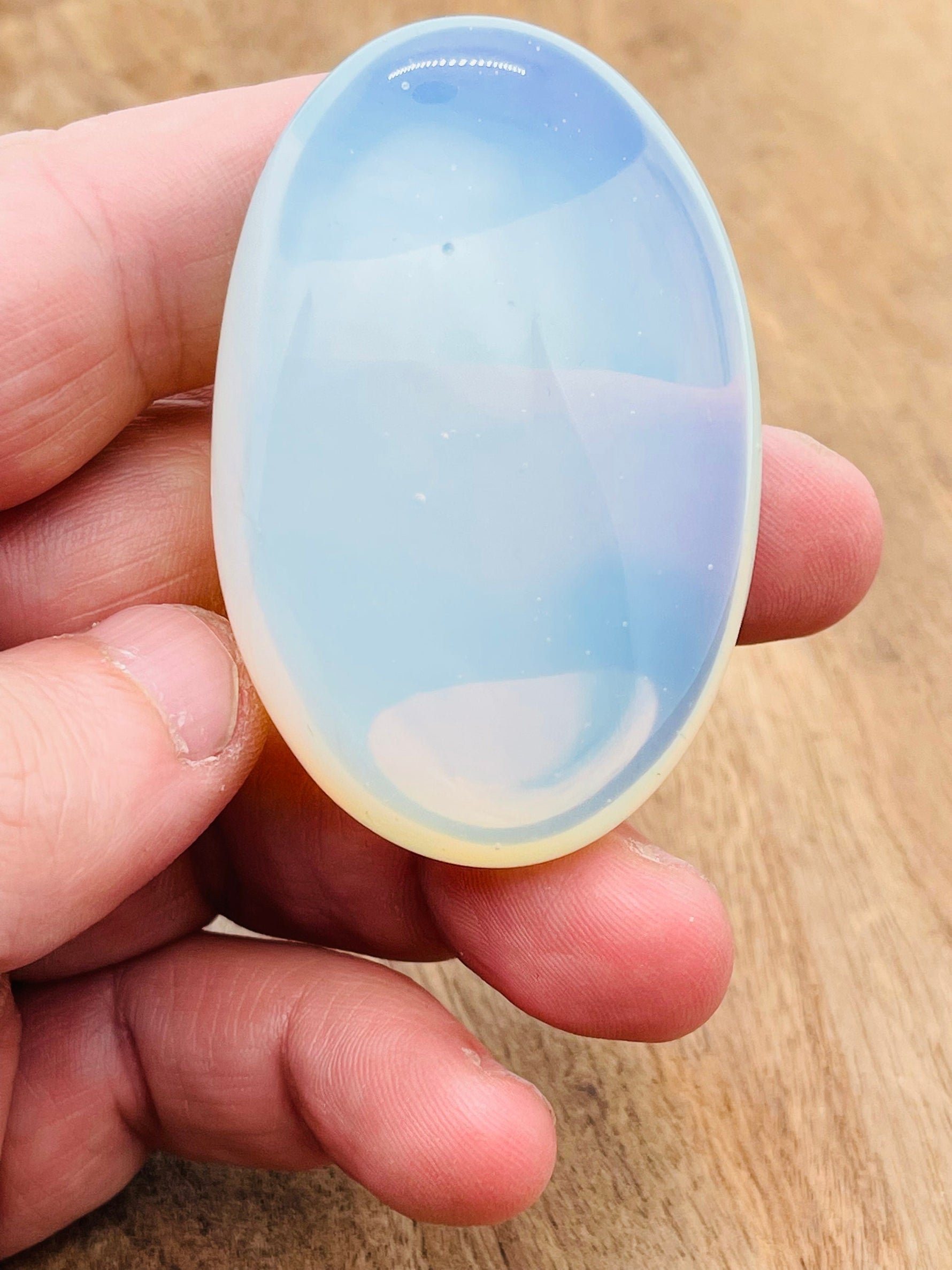 Opalite palm gemstone spa stone, 60x40mm, smooth polished healing crystal from GemstoneGO, ideal for relaxation and meditation.