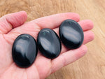 Obsidian palm gemstone spa stone, 45x35mm, smooth and polished black healing stone for relaxation and meditation.