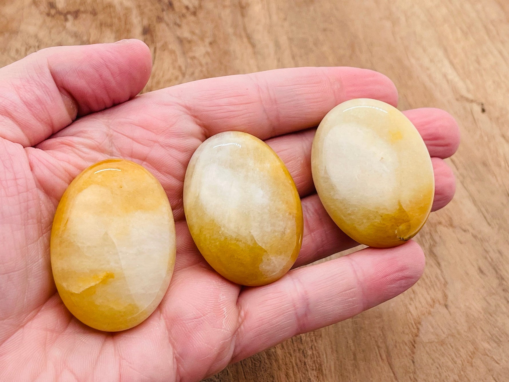 Yellow aventurine palm gemstone spa stone, 45x35mm, showcasing smooth, polished yellow aventurine for relaxation and healing.