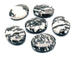 Zebra Calcite Palm Gemstone spa stone, 45x35mm, showcasing black and white striped patterns, suitable for meditation or relaxation.