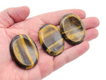 Tiger Eye worry stone from GemstoneGO, smooth 4.5x3.5cm crystal for stress relief and soothing handheld meditation.