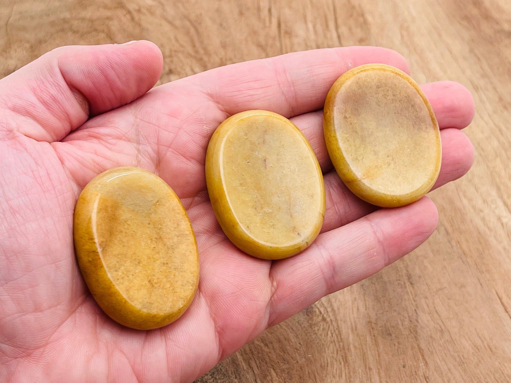 Yellow jade worry stone from GemstoneGO showing a 4.5x3.5cm smooth, polished crystal for stress relief and soothing tactile experience.