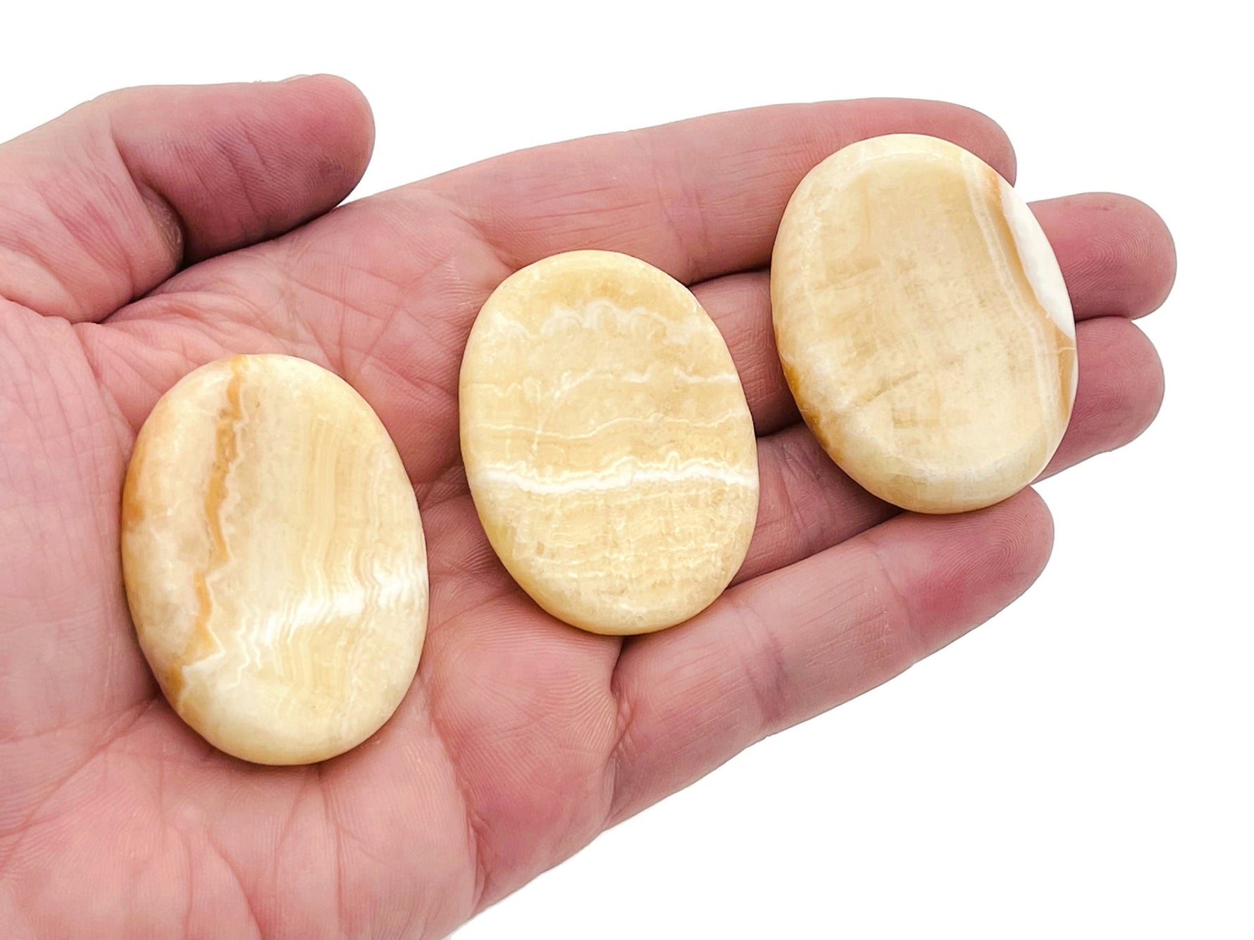 Yellow calcite worry stone from GemstoneGO, soothing crystal with a smooth 4.5x3.5cm polished surface, ideal for stress relief.