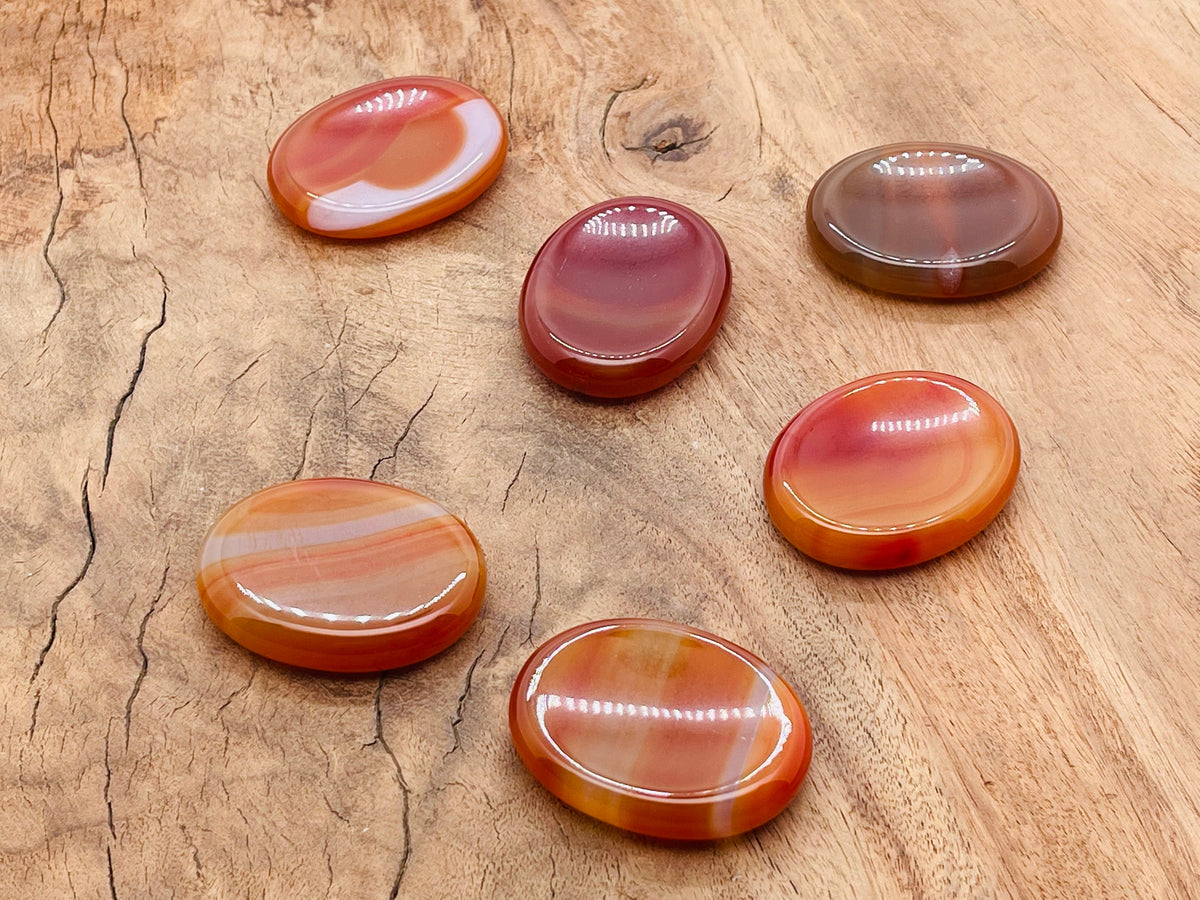 Smooth carnelian worry stone from GemstoneGO, 4.5x3.5cm, featuring vibrant orange crystal for soothing stress relief.