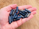 Sodalite terminated carved point gemstone from GemstoneGO, 33mm, showing vibrant blue and white natural mineral patterns.