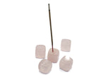 Handmade rose quartz crystal incense holder with carved details, designed for holding incense sticks gracefully.