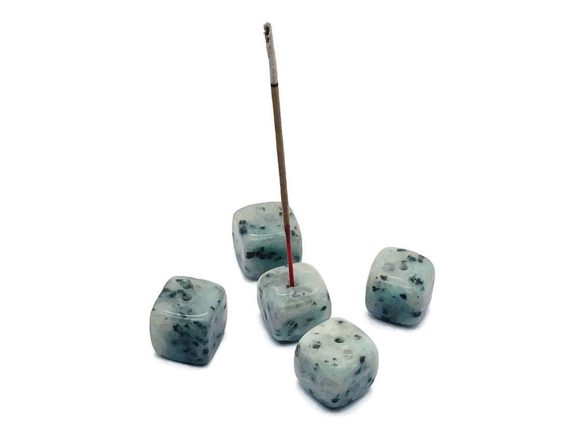 Handmade Kiwi Jasper crystal incense holder with carved design, perfect for holding incense sticks in a natural gemstone display.