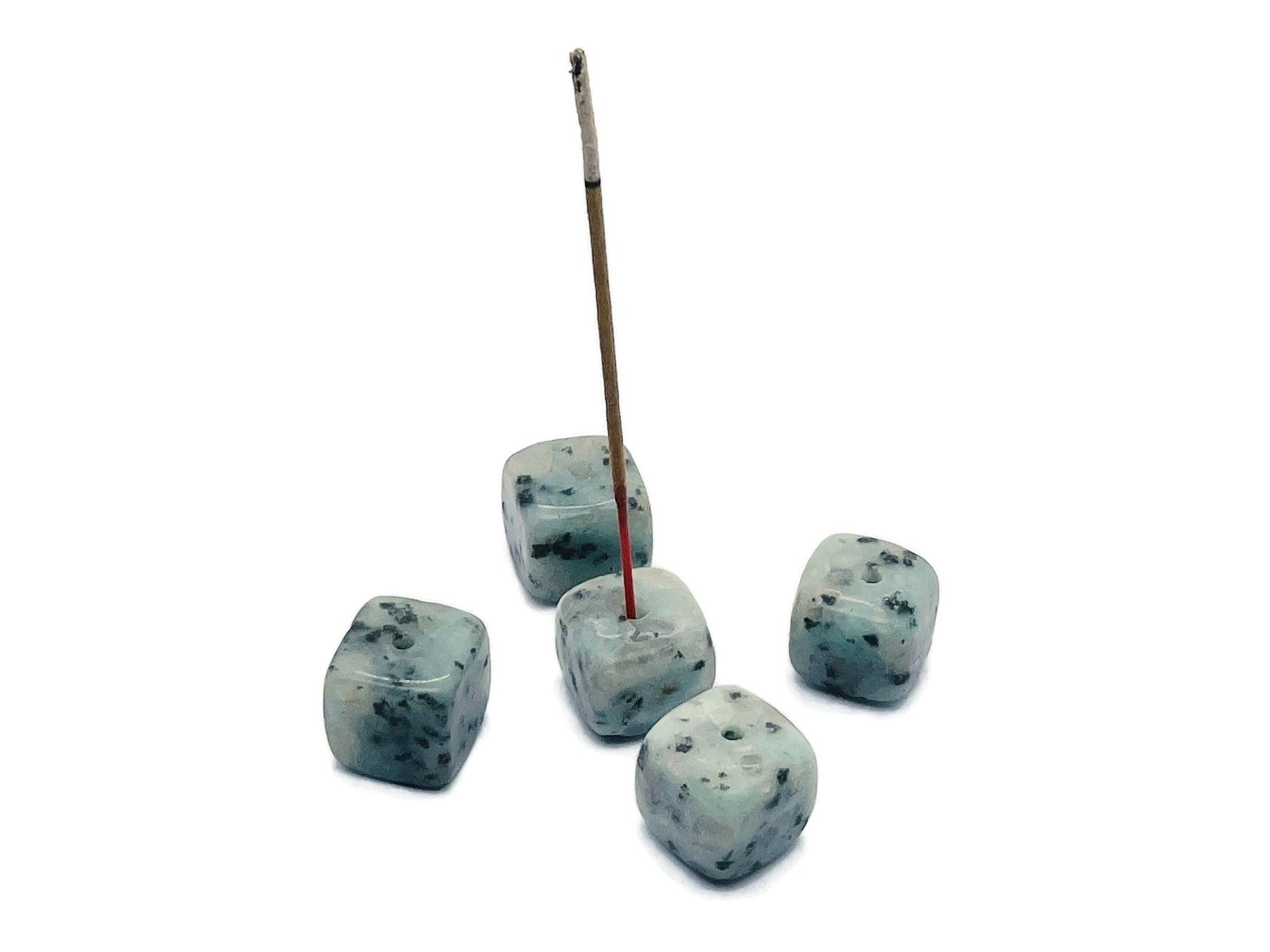Handmade Kiwi Jasper crystal incense holder with carved design, perfect for holding incense sticks in a natural gemstone display.