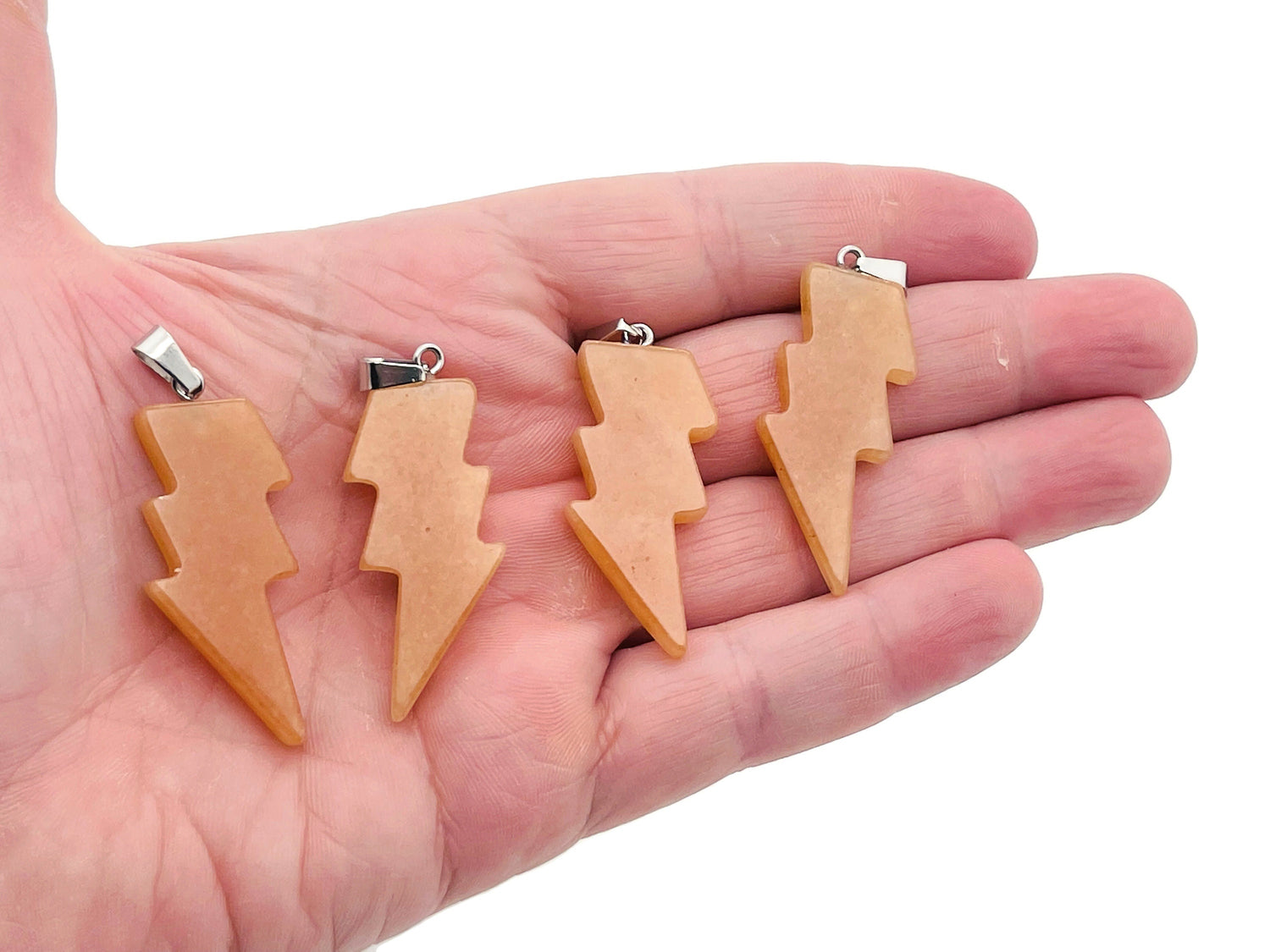 Orange aventurine lightning crystal pendant from GemstoneGO featuring a vibrant lightning stone design.