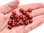 Carnelian ball beads with crystal pendant, showcasing vibrant orange stones and jewelry design from GemstoneGO.