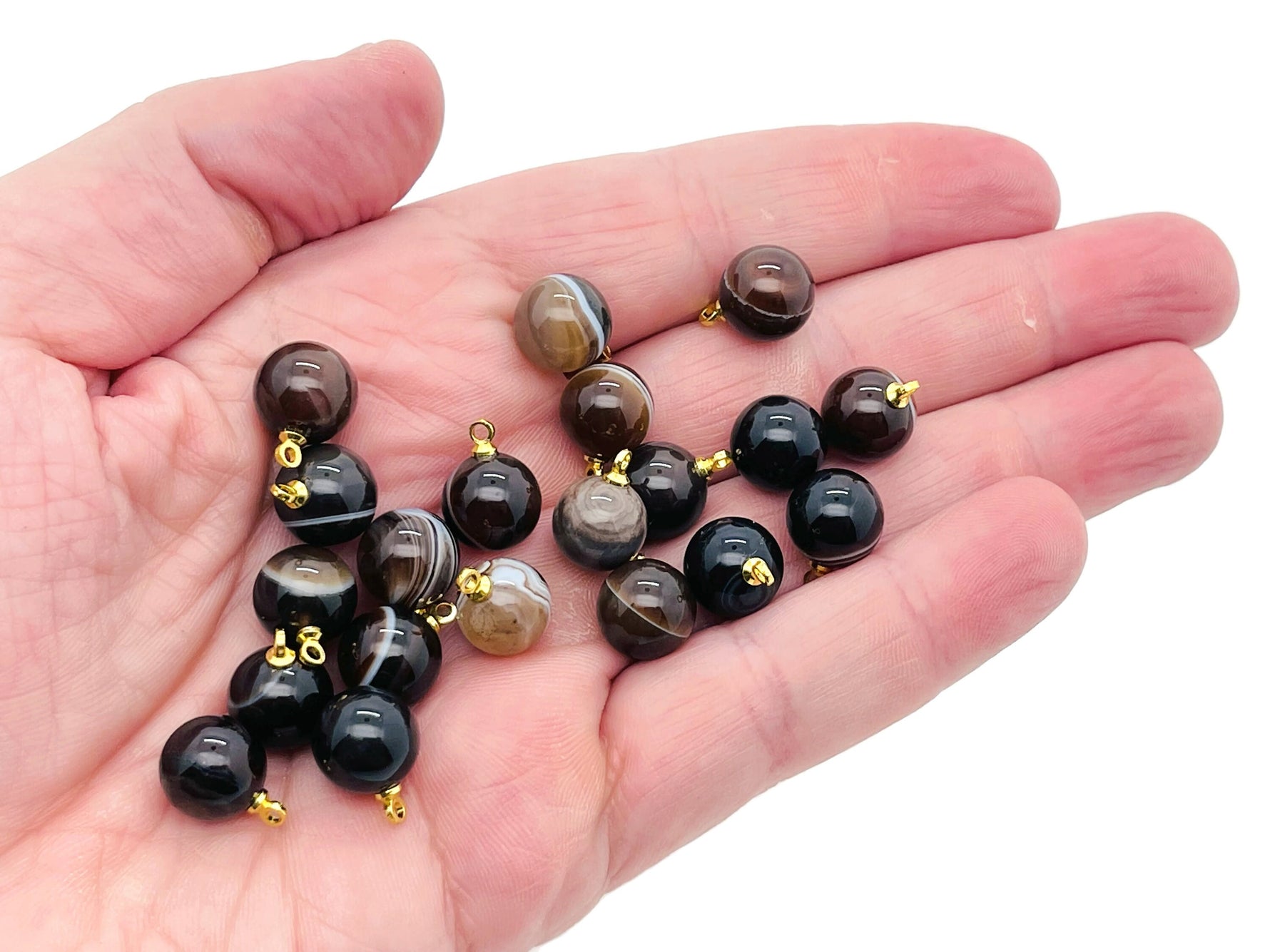Black agate ball beads with crystal pendant, jewelry stone by GemstoneGO, showcasing smooth black gemstone and sparkling crystal detail.