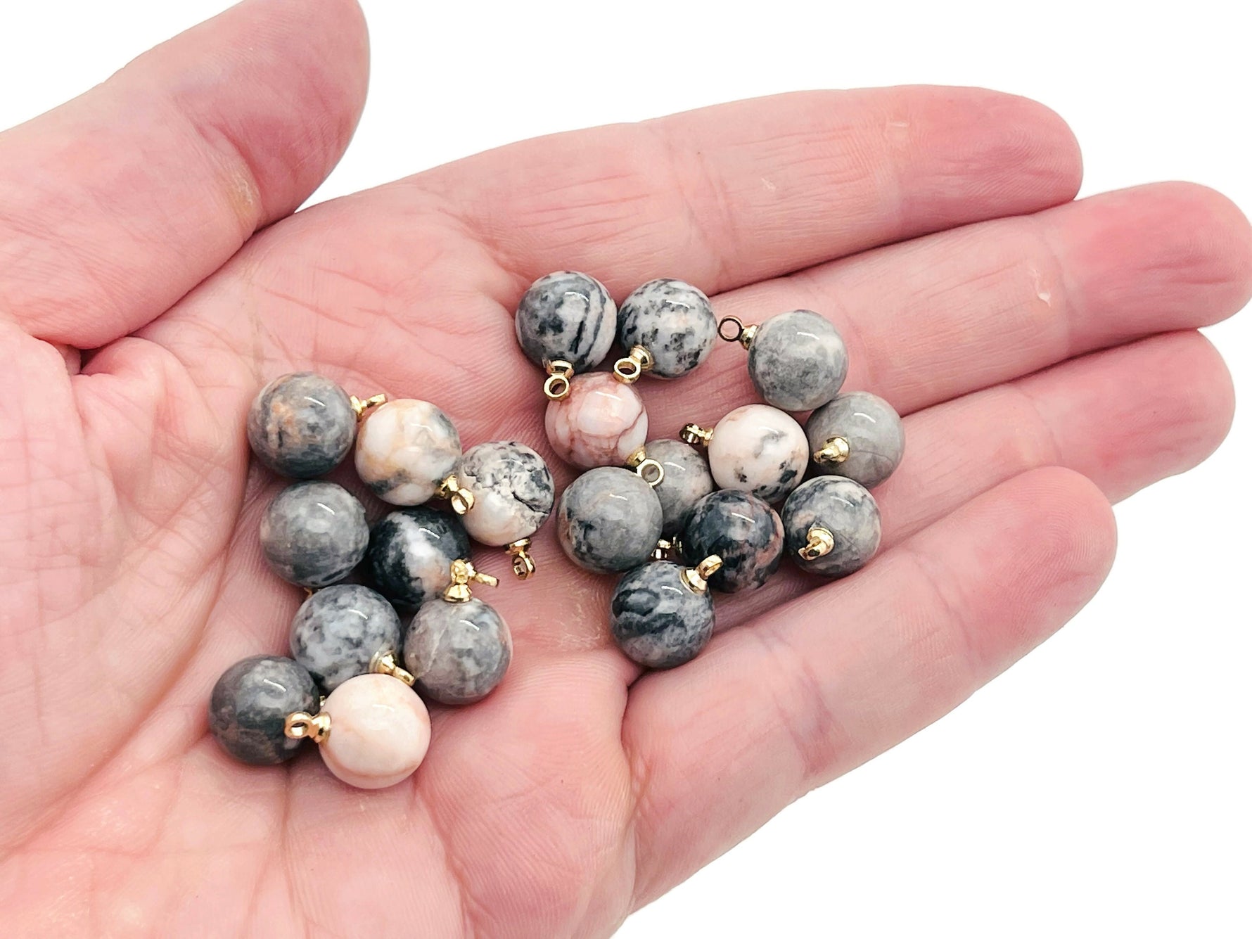 Pink Zebra Calcite ball beads crystal pendant from GemstoneGO, showcasing smooth pink and white gemstone jewelry stone.
