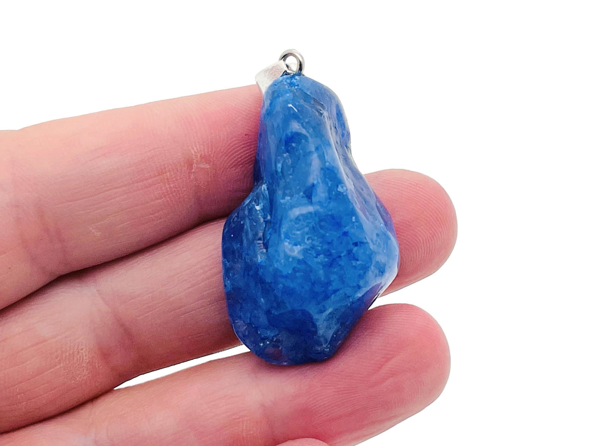 Blue agate crystal pendant with silver bail, featuring a polished oval-shaped loose stone, ideal for jewelry making or reiki healing.