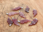 Strawberry Quartz Lightning Crystal Pendant featuring a vibrant pink gemstone and lightning-shaped silver setting from GemstoneGO.