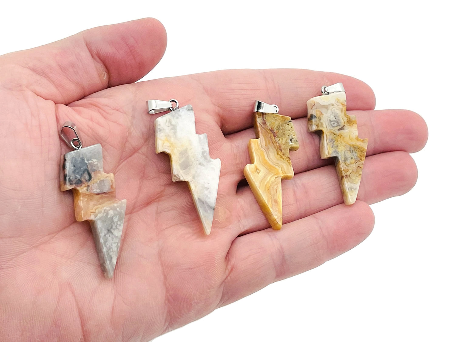 Crazy Lace Agate lightning crystal pendant featuring vibrant multicolored lace patterns and a lightning-shaped gemstone setting.