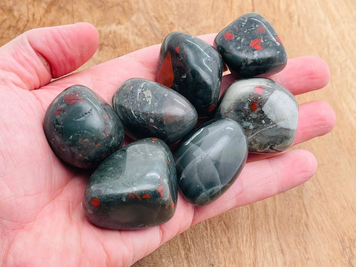 African Bloodstone tumbled gemstone from GemstoneGO, showcasing a smooth, polished dark green stone with red bloodstone inclusions.