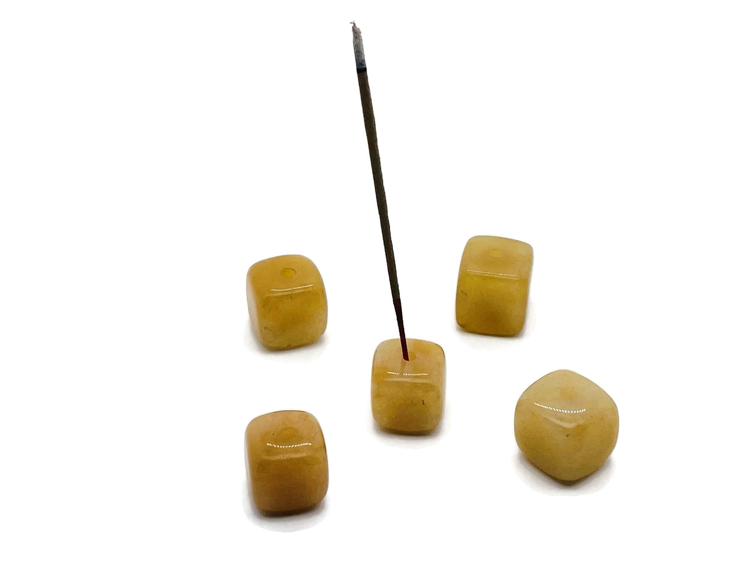 Handmade yellow aventurine crystal incense holder with carved design, perfect for holding incense sticks securely.