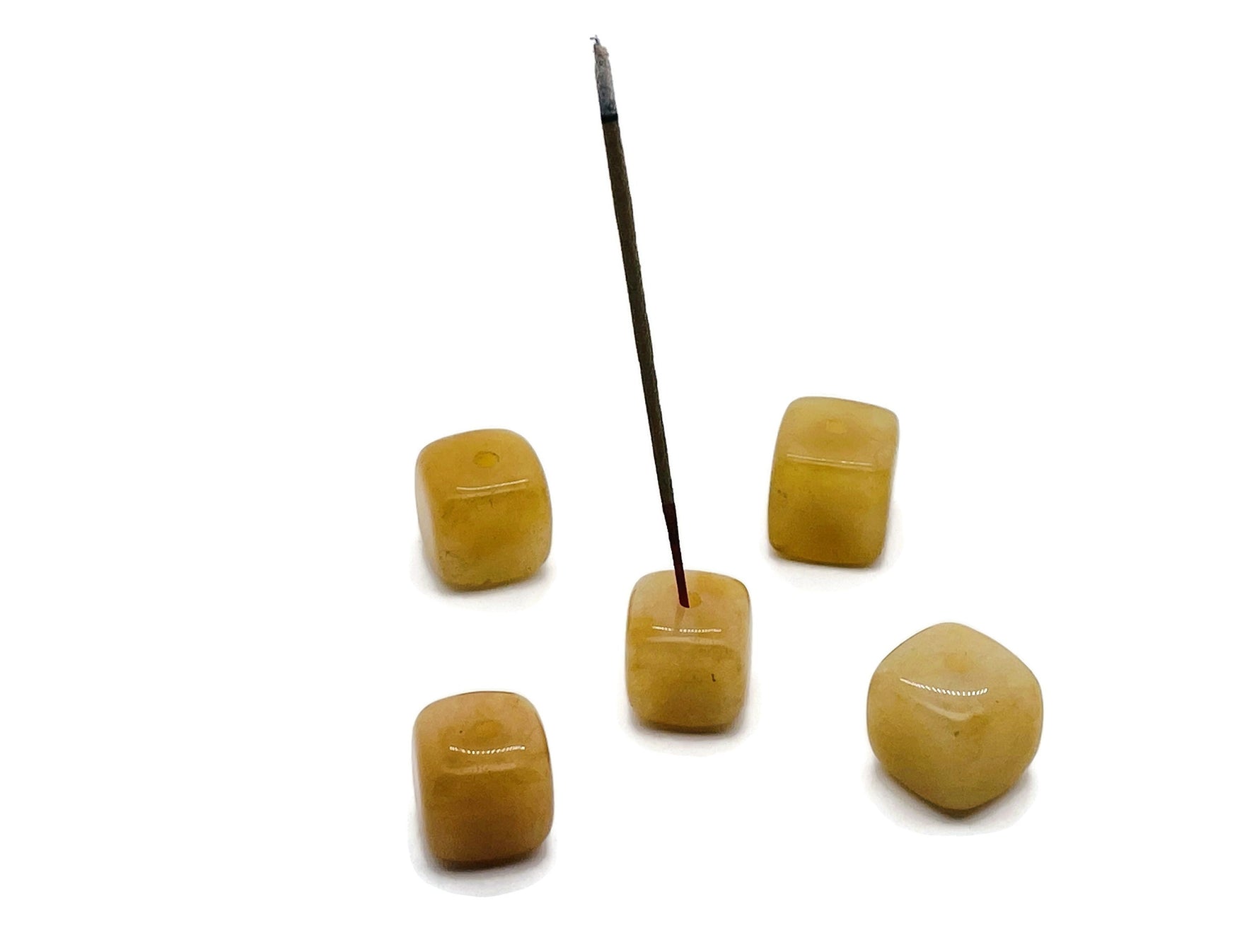 Handmade yellow aventurine crystal incense holder with carved design, perfect for holding incense sticks securely.