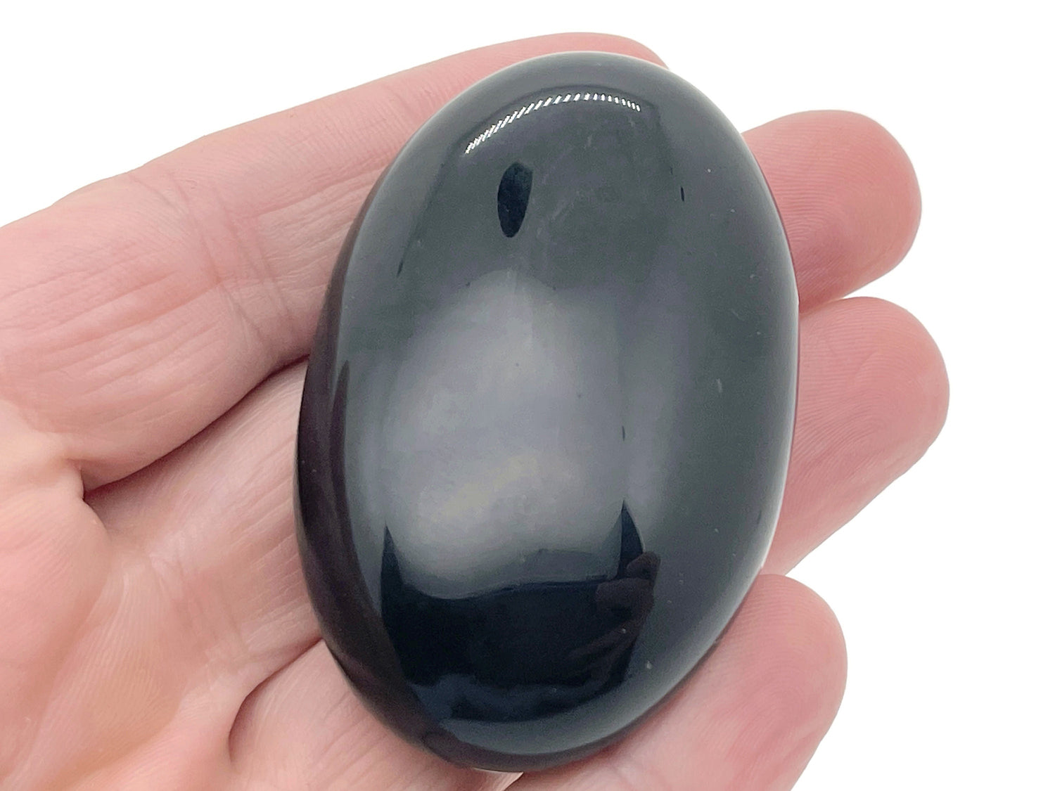 Obsidian palm gemstone spa stone, 60x40mm, smooth black volcanic stone for relaxation and massage therapy.
