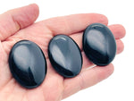 Obsidian palm gemstone spa stone, 45x35mm, smooth and polished black volcanic stone for relaxation and healing.