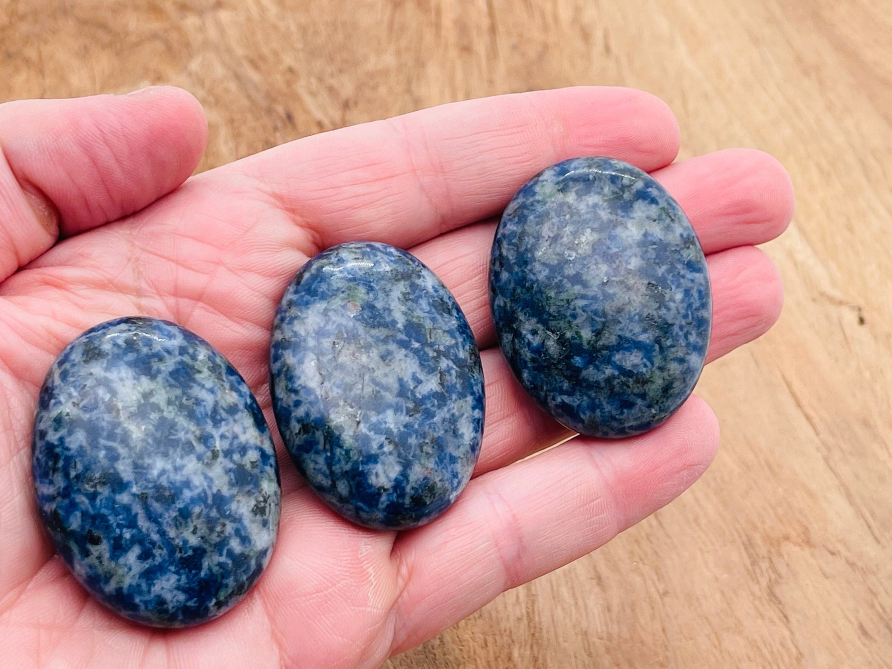 Blue Spot Jasper palm gemstone spa stone, 45x35mm, smooth polished natural stone with vibrant blue spots, ideal for relaxation and meditation.