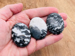 Zebra Calcite palm gemstone spa stone, 45x35mm, from GemstoneGO, featuring distinctive black and white striped patterns.