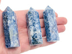 Blue Spot Jasper obelisk tower crystal from GemstoneGO, featuring vibrant blue and brown patterns on a polished stone.