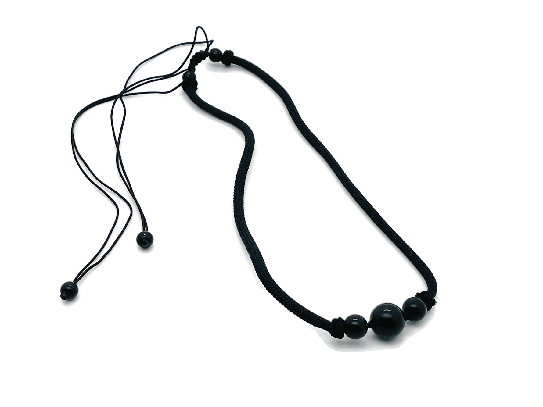 Obsidian sphere crystal pendant necklace with cord, featuring a polished black gemstone for healing and spiritual energy.