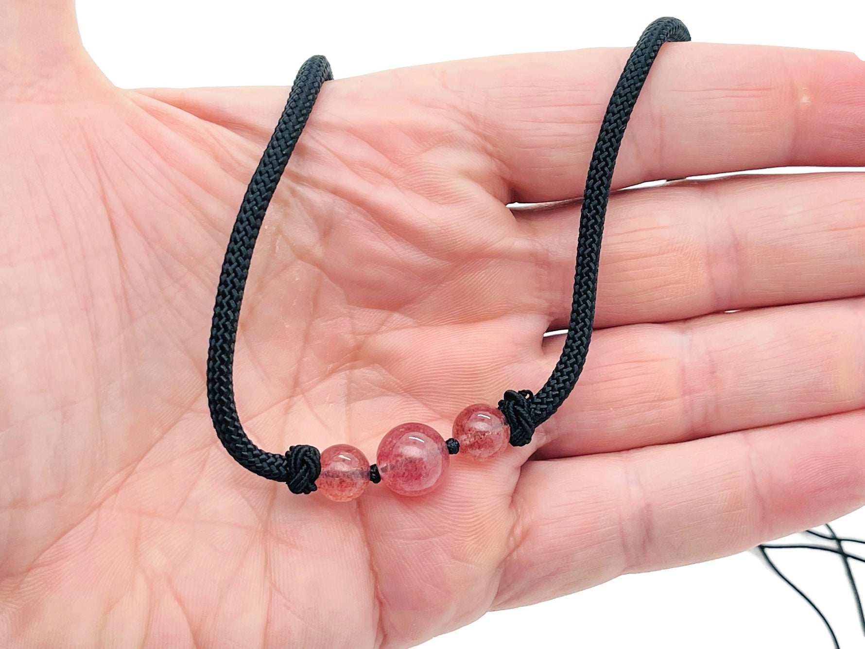 Strawberry Quartz sphere pendant necklace from GemstoneGO featuring a polished pink quartz crystal on a delicate chain.