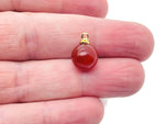 Carnelian ball beads with crystal pendant, showcasing vibrant orange stones and sparkling gemstones in jewelry design.