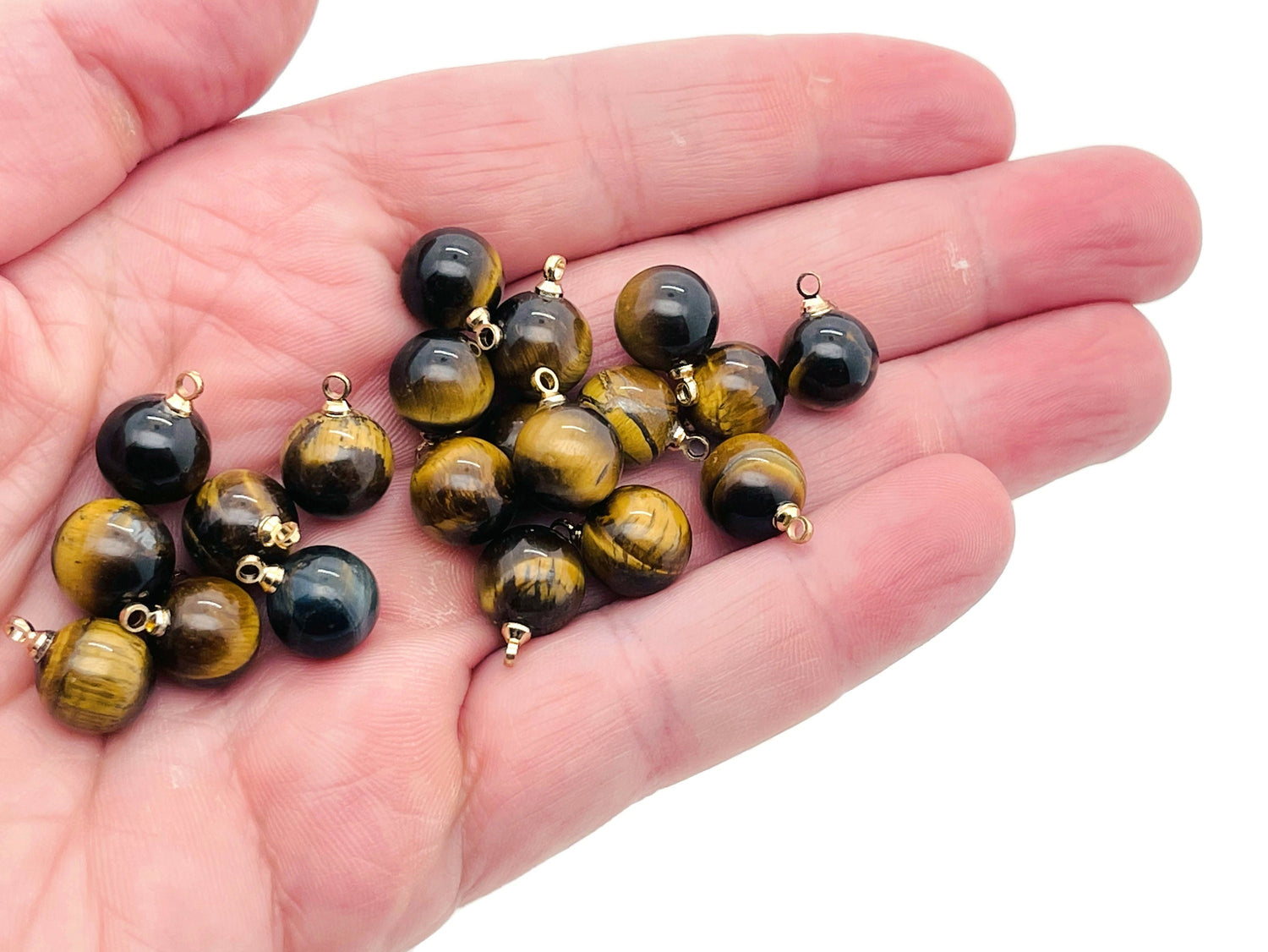 Tiger Eye ball beads crystal pendant from GemstoneGO featuring a polished, smooth stone jewelry accessory with natural golden-brown hues.