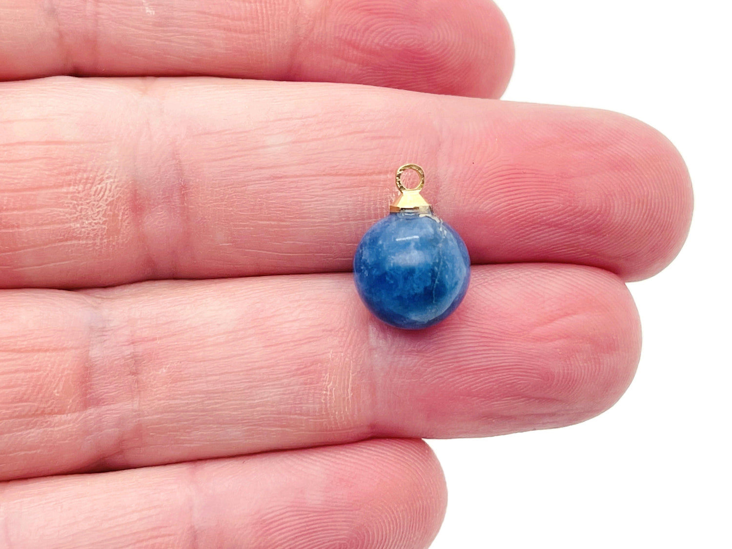 Sodalite ball beads crystal pendant from GemstoneGO featuring deep blue and white gemstone jewelry stone on a string.