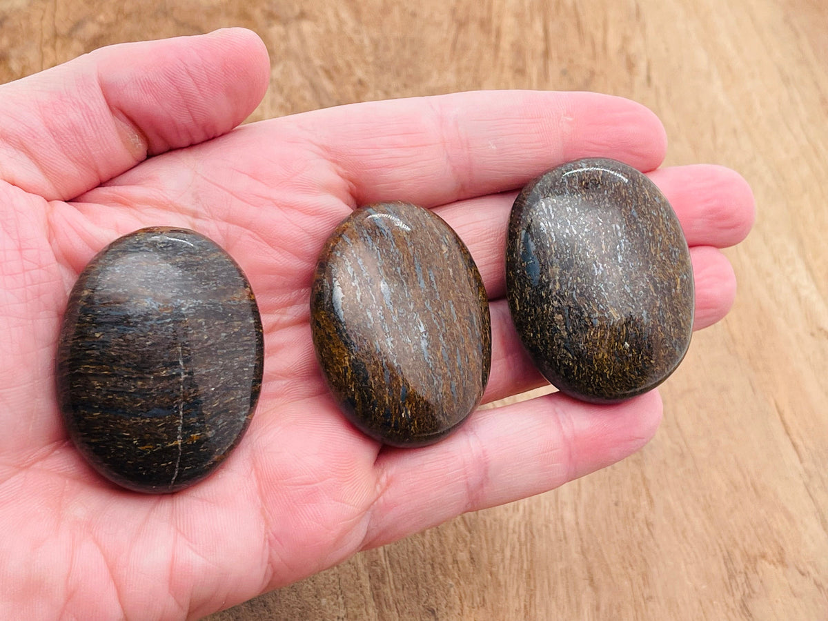 Bronzite palm gemstone spa stone, 45x35mm, from GemstoneGO, showing smooth, polished surface with natural bronze-brown color.
