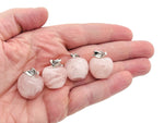 Mini rose quartz apple crystal pendant from GemstoneGO featuring a polished pink quartz apple-shaped gemstone on a silver chain.