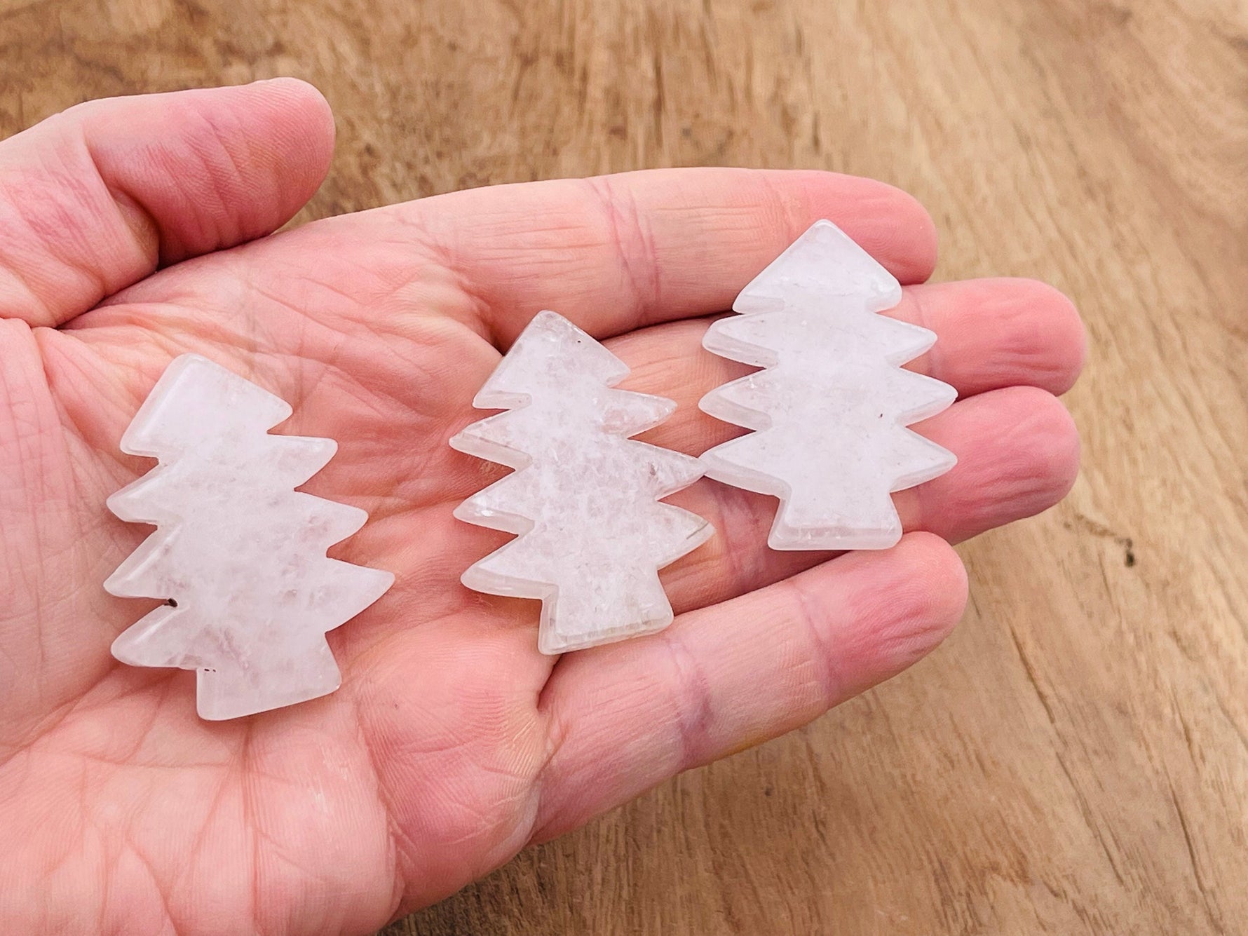 Handmade clear quartz pine tree gemstone carving with detailed tree design, showcasing natural stone texture and craftsmanship.
