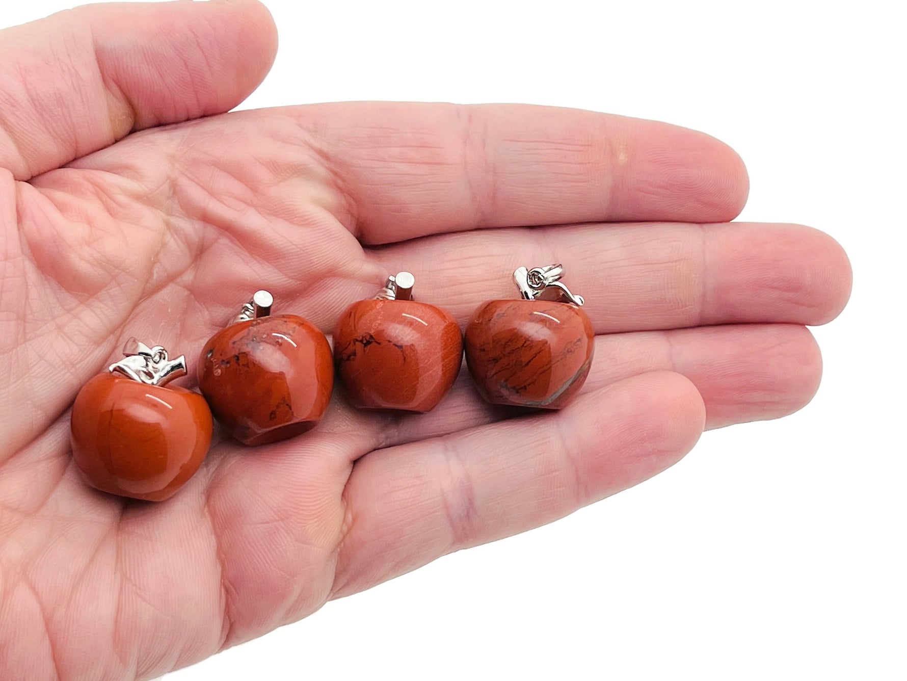 Red Jasper apple-shaped crystal pendant from GemstoneGO, featuring a mini crystal design with vibrant red stone and detailed craftsmanship.