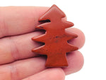 Handmade red jasper pine tree gemstone carving, detailed natural stone sculpture of a pine tree with vibrant red hues.