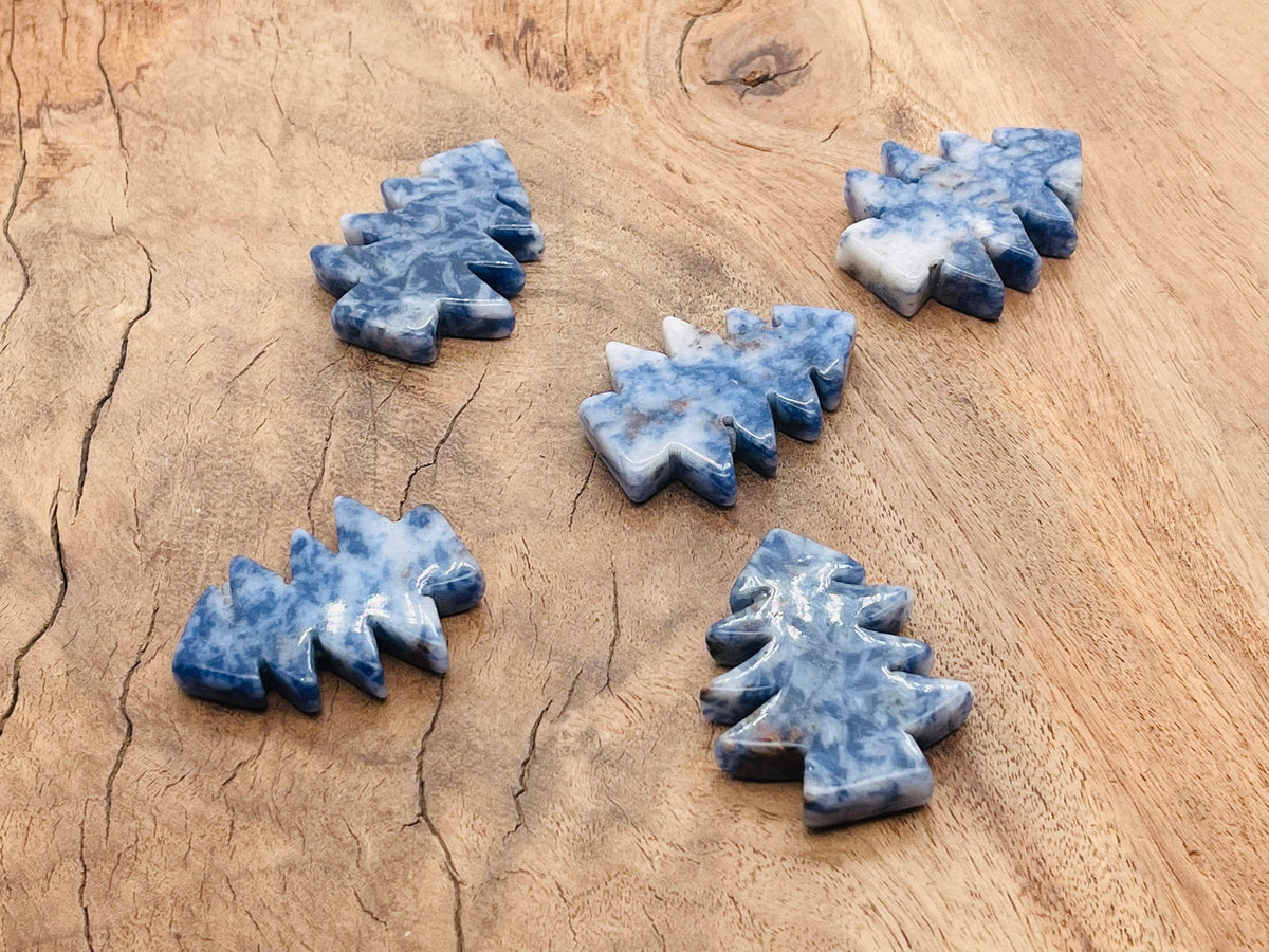 Handmade Blue Spot Jasper pine tree carving gemstone, showcasing detailed craftsmanship and vibrant blue spots on a polished stone.