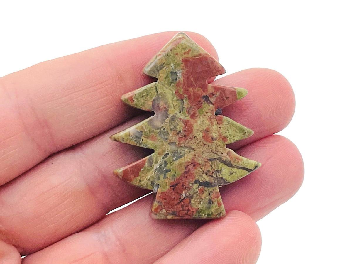 Handmade Unakite gemstone pine tree carving featuring detailed green and pink stone with natural stone texture and intricate carving.