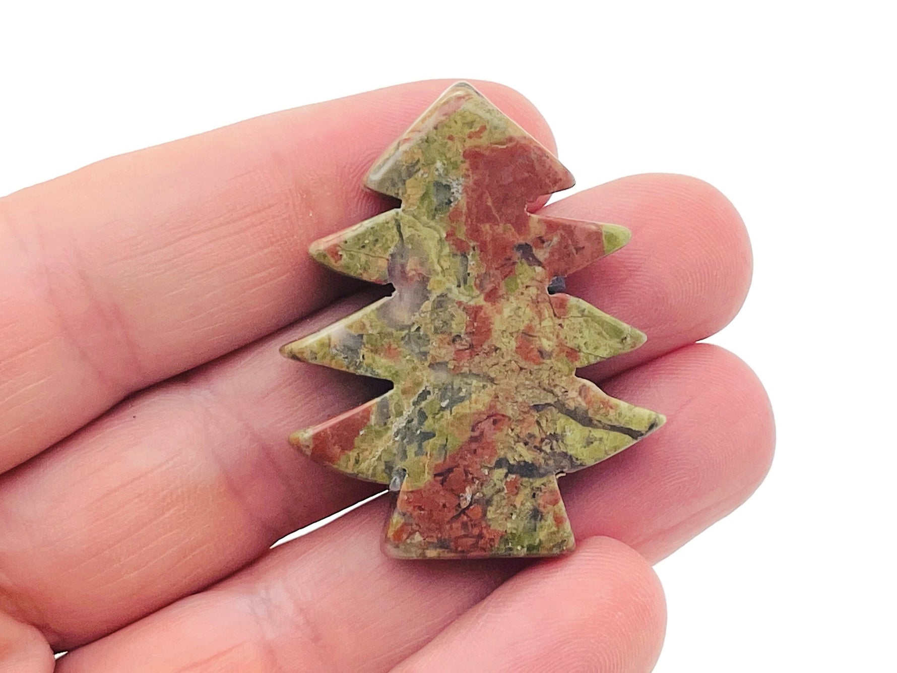 Handmade Unakite gemstone pine tree carving featuring detailed green and pink stone with natural stone texture and intricate carving.