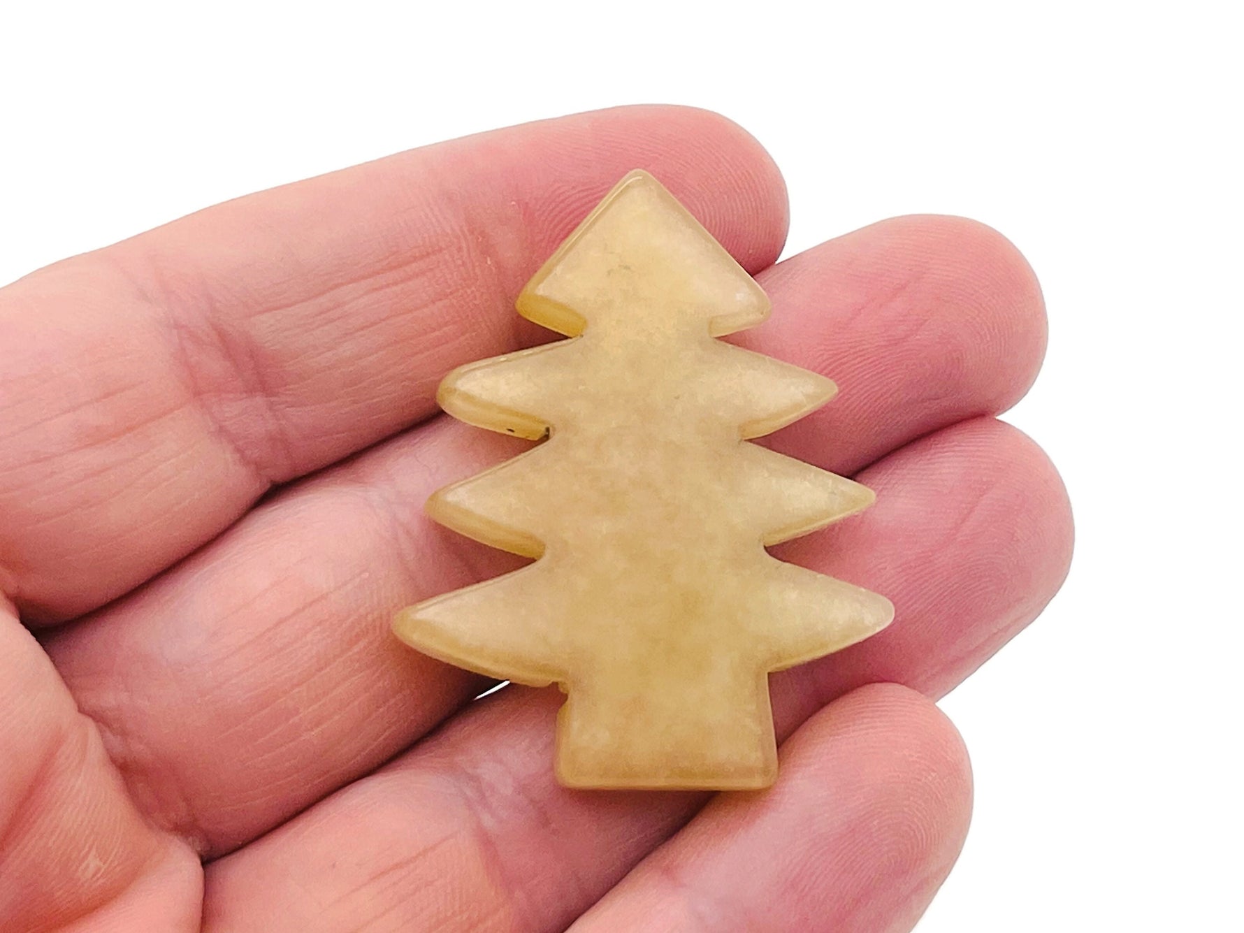 Handmade yellow aventurine gemstone pine tree carving, detailed miniature tree sculpture on a natural stone base.