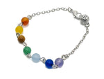 Crystal chakra bracelet with seven stones from GemstoneGO, featuring colorful polished gemstone beads on an elastic band.
